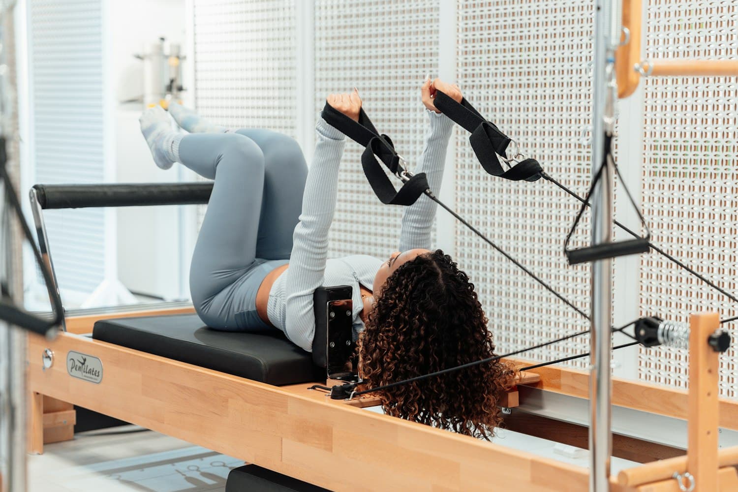 Reformer Pilates session in a bright studio